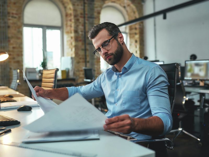 construction-concept-concentrated-bearded-engineer-in-eyeglasses-and-formal-wear-looking-at.jpg