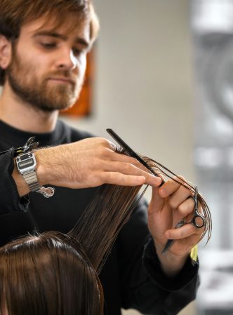 professional-male-hairdresser-cutting-female-hair-in-salon.jpg