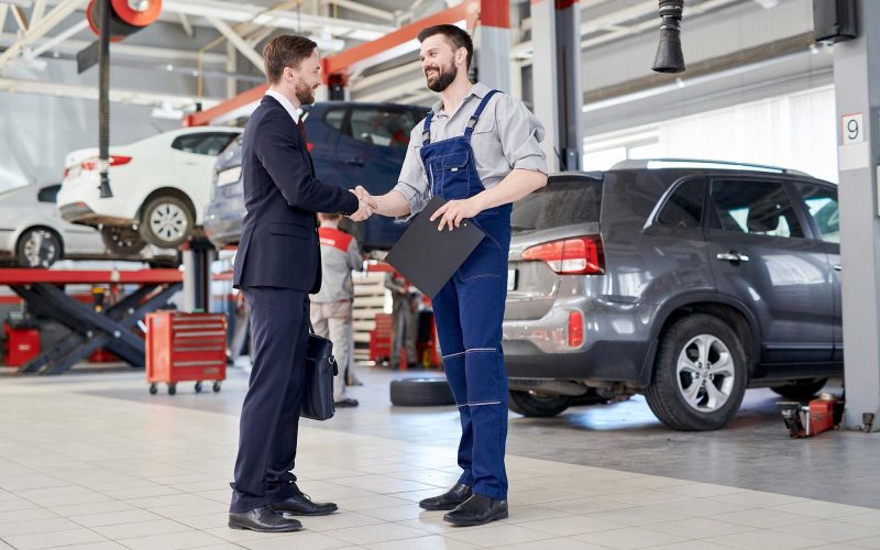 worker-shaking-hands-with-client-in-car-service-sh-small.jpg